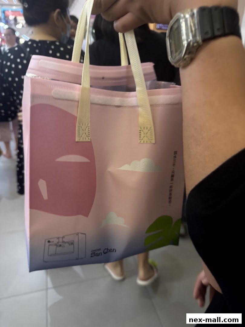 A person holds a pink shopping bag with clouds and leaves, from CHICHA San Chen.