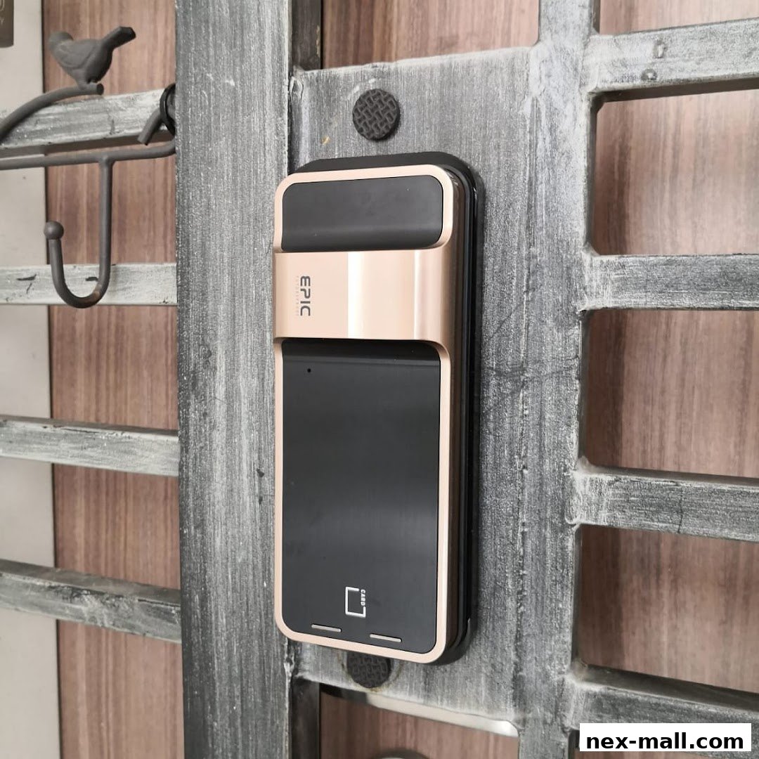 A close-up of an EPIC digital door lock with a gold and black finish mounted on a gate.