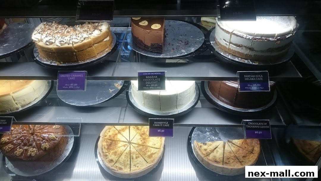 A display case filled with various cakes and quiches, with price labels visible.