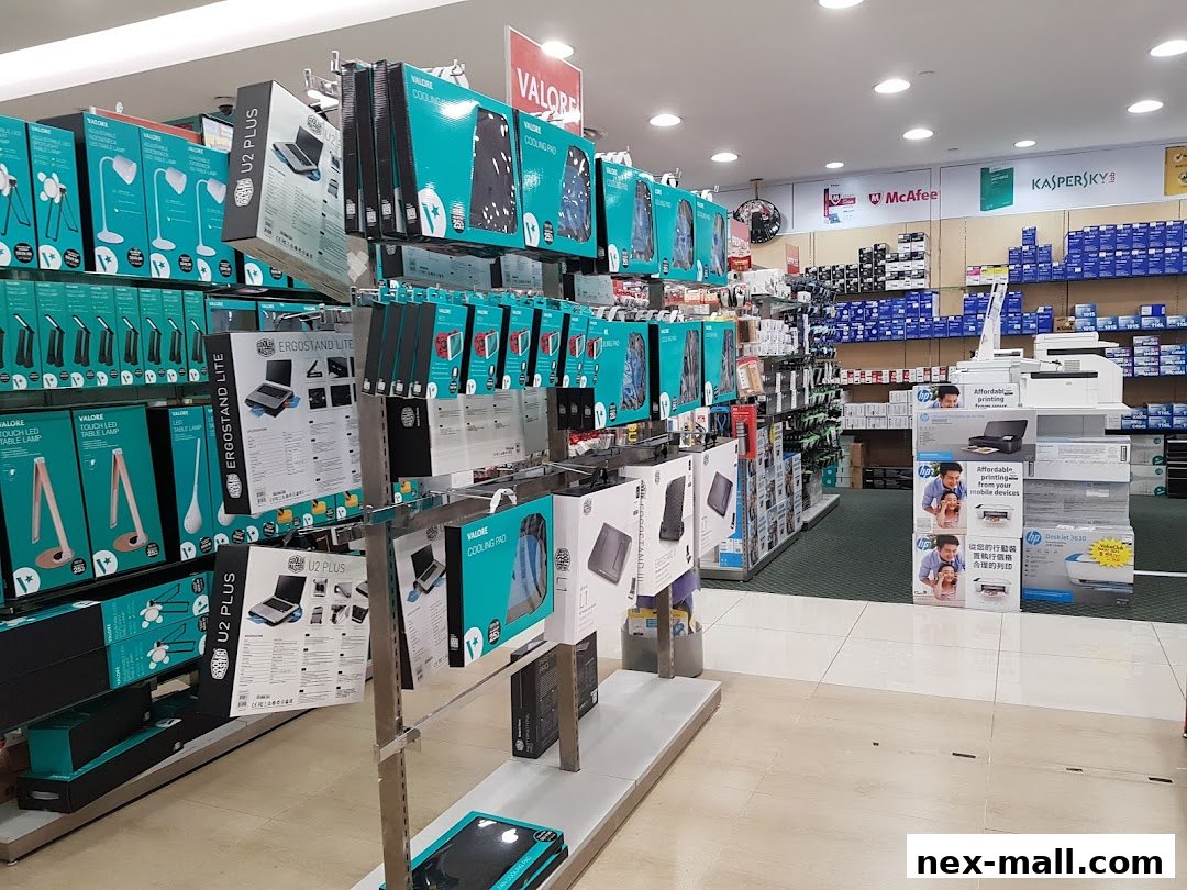 Interior view of a Challenger NEX electronics store showcasing various computer accessories and printers.
