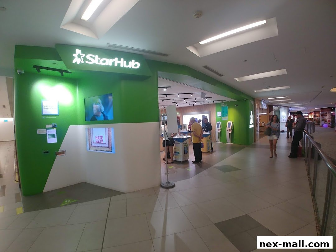 The StarHub shop front with green and white accents, featuring digital displays and customers inside.