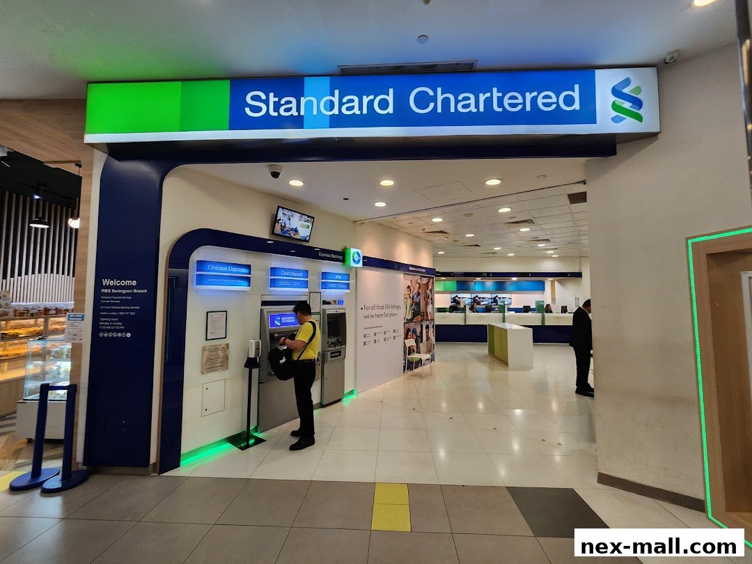 Entrance to a Standard Chartered Bank branch with ATMs and banking counters.