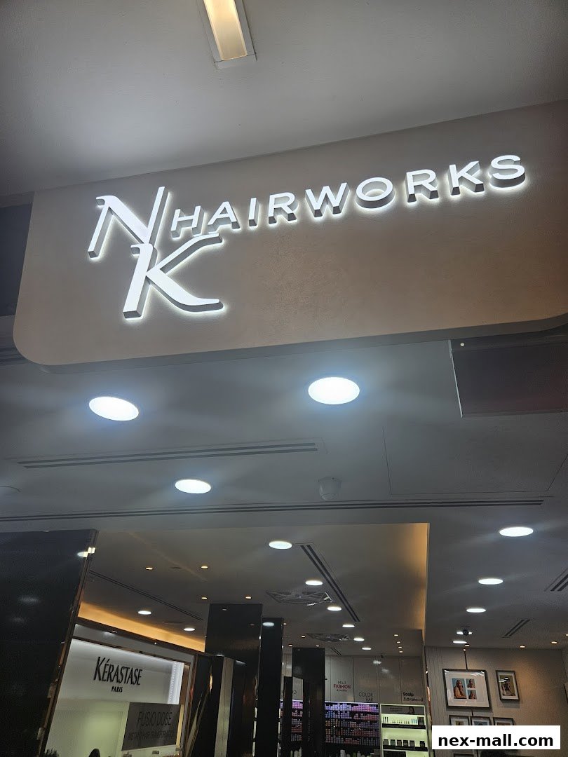 The illuminated sign for NK Hairworks is prominently displayed above the shop entrance.