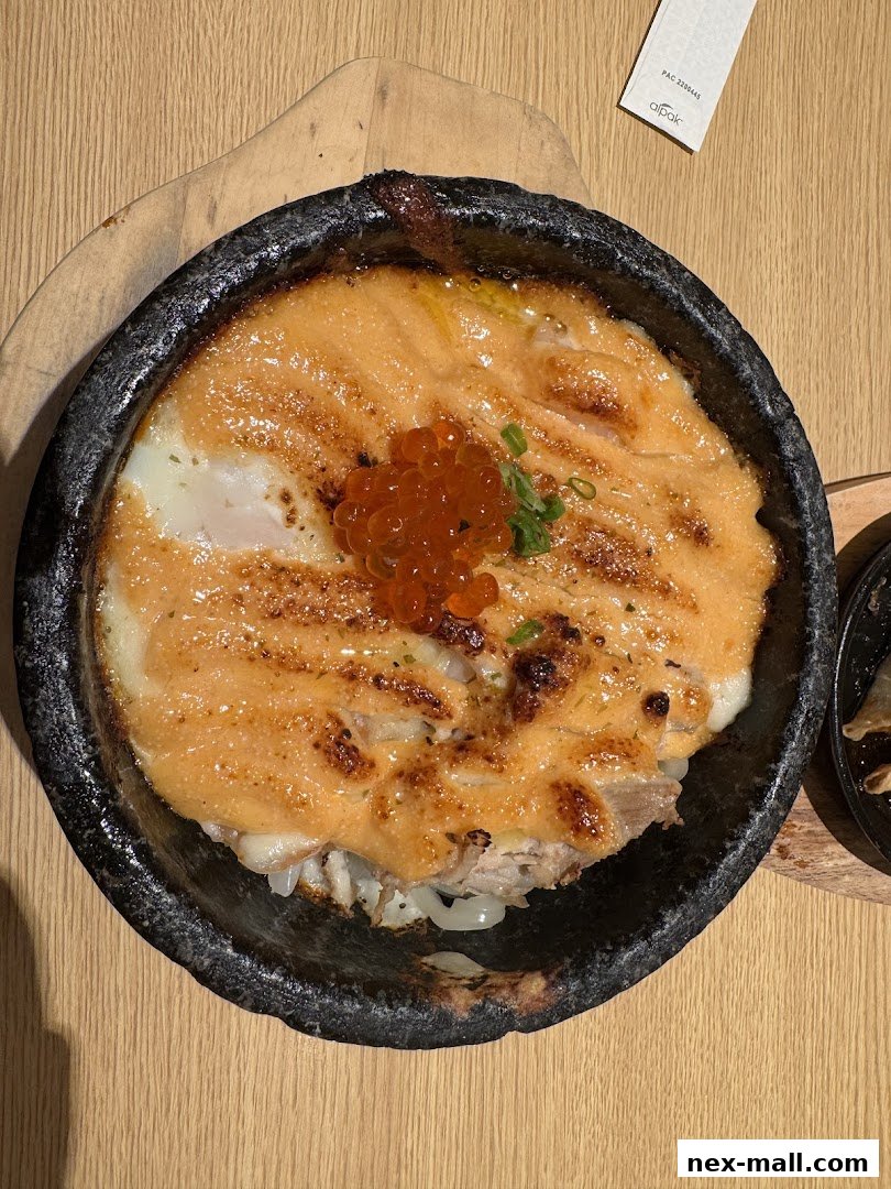 A close-up of a delicious salmon dish with ikura and a runny egg.