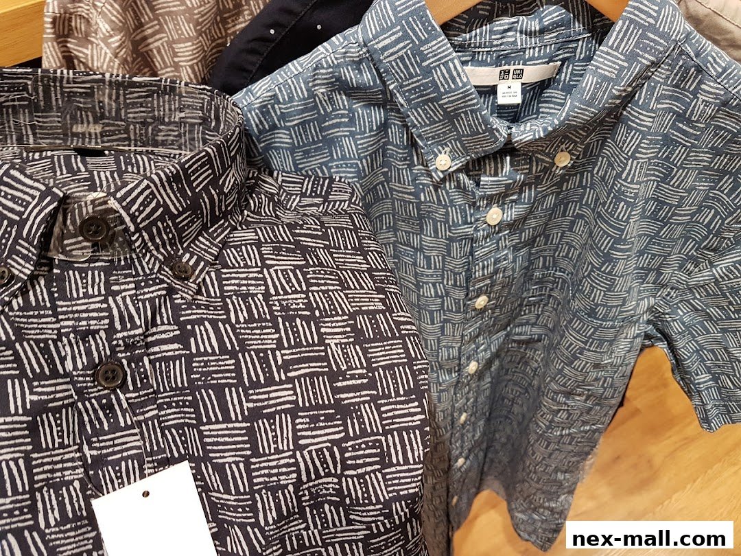 Close-up view of patterned short-sleeved shirts hanging on hangers.