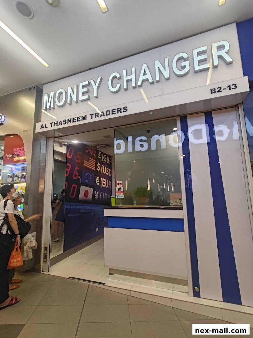 The exterior of a money changer shop with a prominent sign and currency displays.