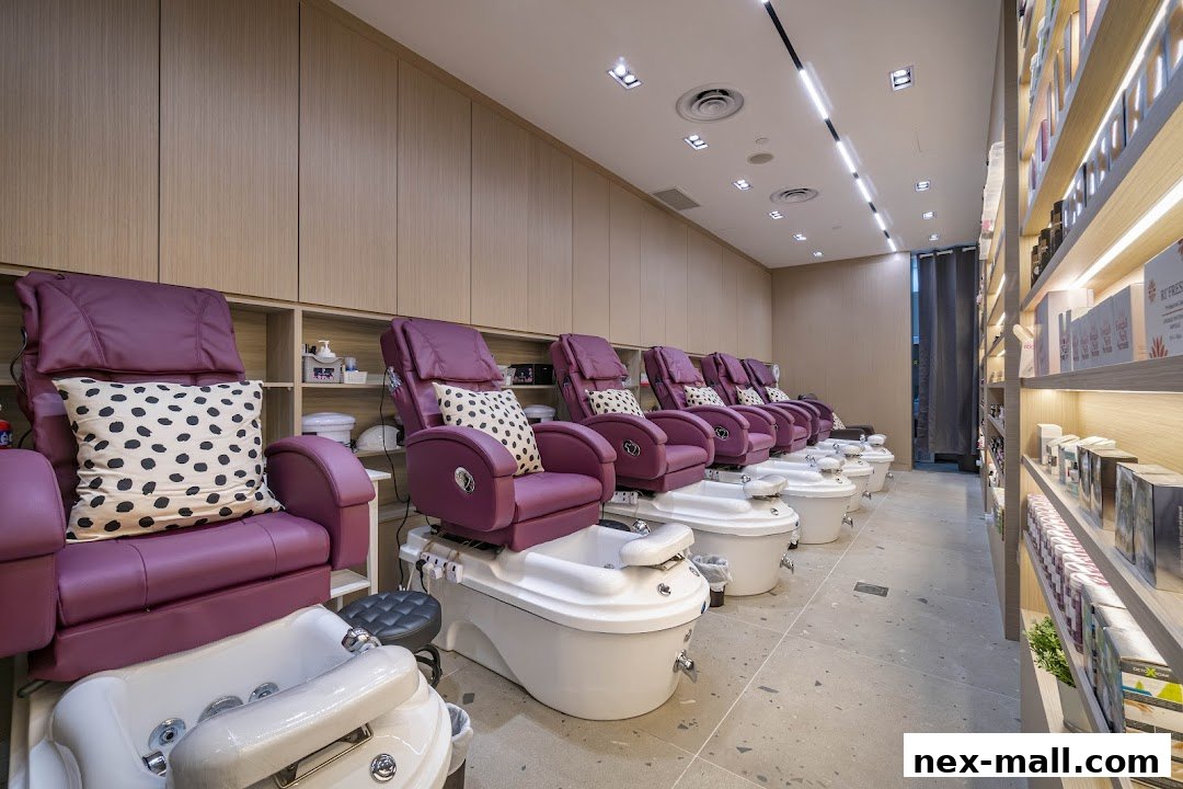 Interior of a nail spa with multiple pedicure chairs and shelves stocked with products.