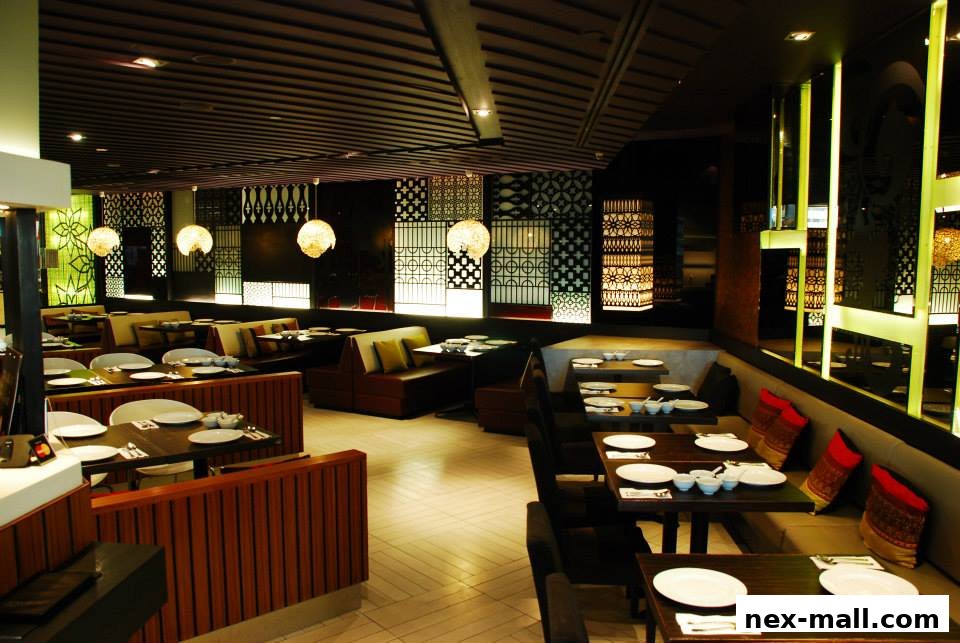 Interior view of a modern Thai restaurant with elegant seating and decorative lighting.
