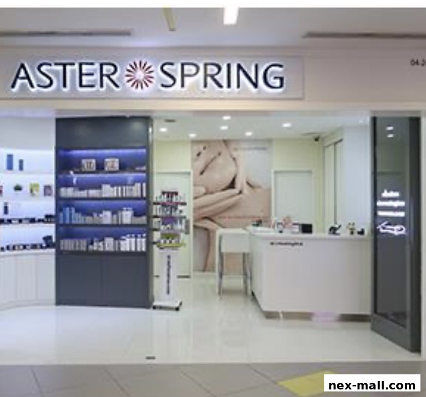 The entrance of Aster Spring NEX, a beauty and wellness store, showcasing products and a reception area.