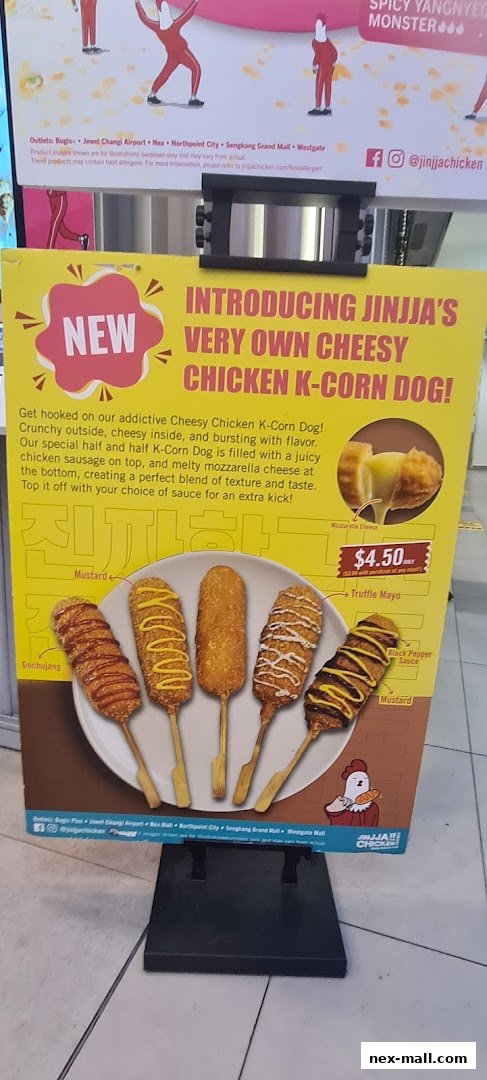 A promotional sign for JINJJA Chicken's new Cheesy Chicken K-Corn Dog.