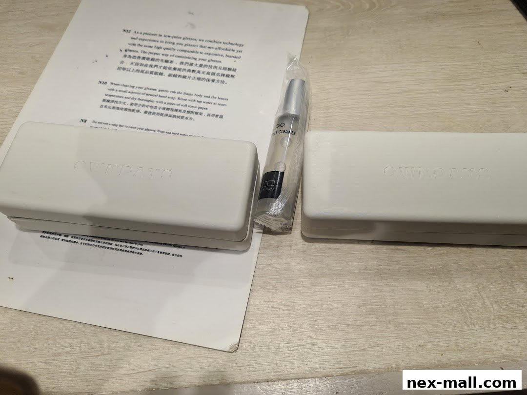 OWNDAYS branded glasses case and lens cleaner on a document.