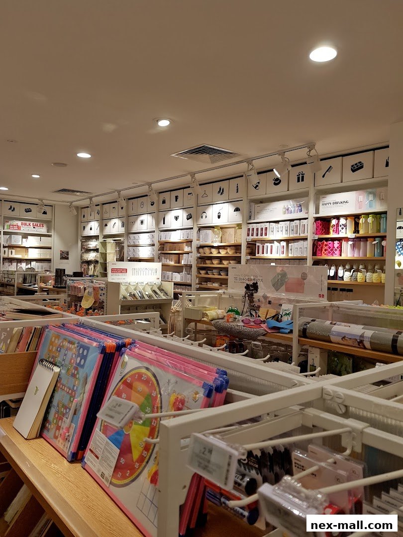 Interior view of a MINISO NEX store showcasing shelves filled with various products like stationery, home goods, and accessories.