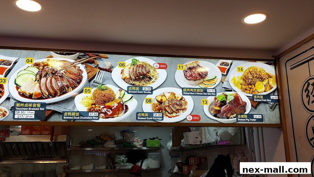 A brightly lit menu board showcasing various braised duck and pork dishes with prices.