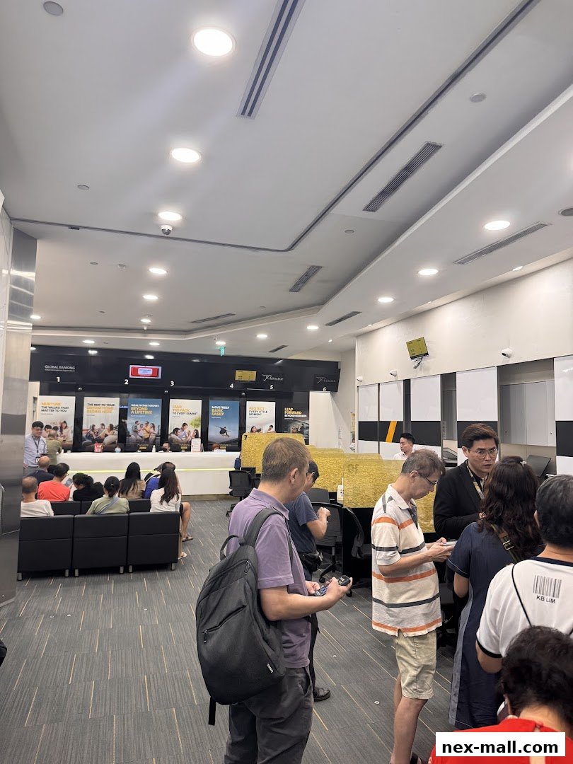 People waiting in line inside a modern bank branch with promotional posters.