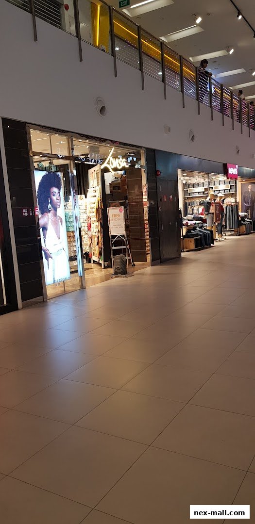 The exterior of the Lovisa jewelry store with a display of jewelry and a promotional sign.