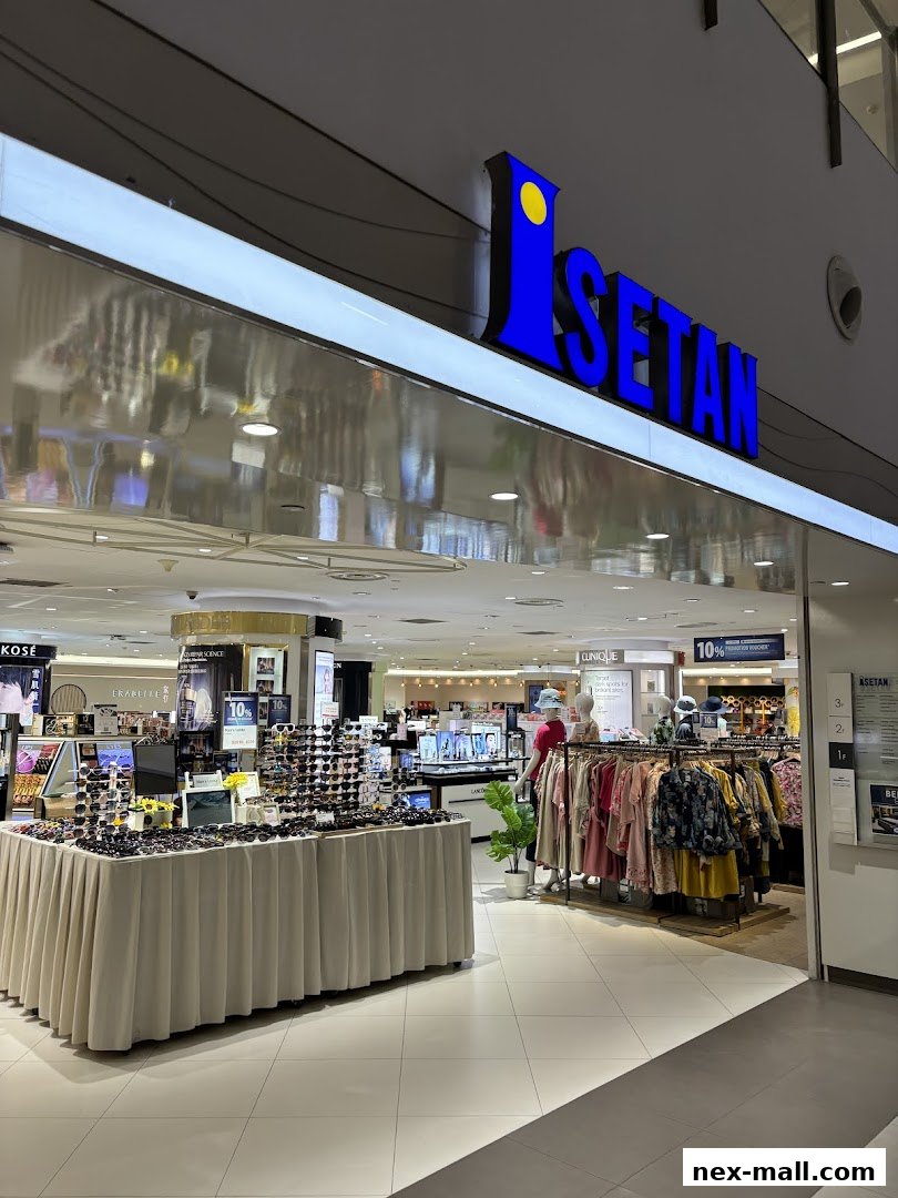 The Isetan department store entrance featuring a sunglasses display and clothing racks.
