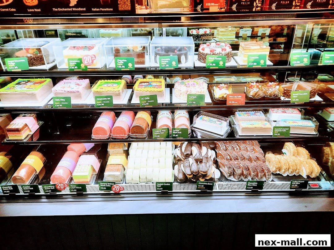 A display case filled with a variety of colorful cakes and pastries, showcasing different flavors and designs.