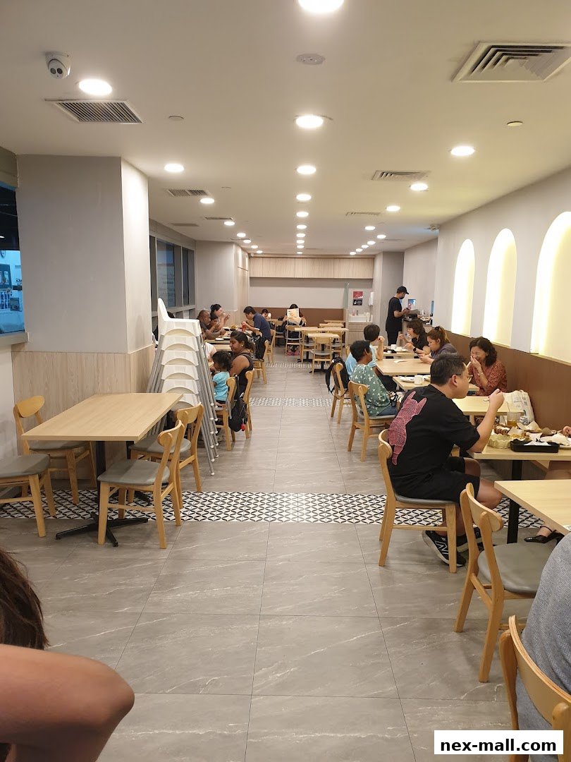 Interior view of a busy restaurant with diners seated at tables.