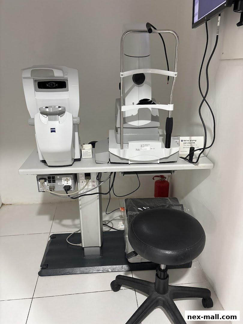 Optical examination equipment and a stool in a clean, well-lit room.