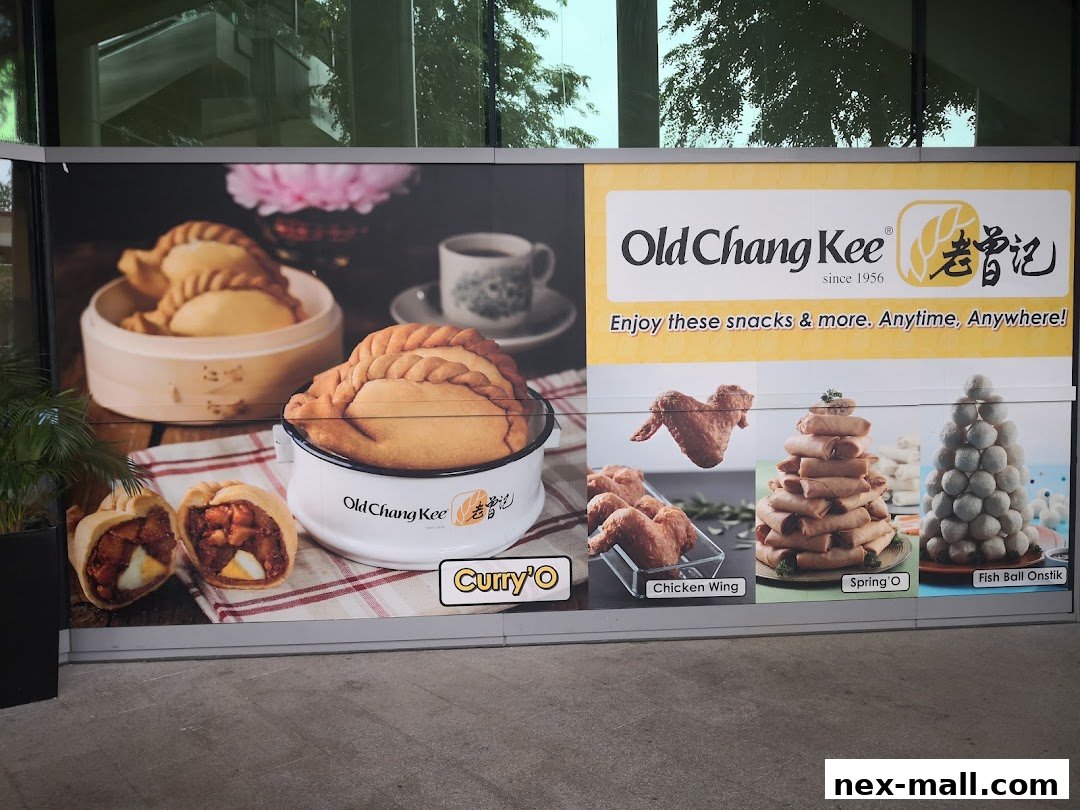 A mural showcasing Old Chang Kee's popular snacks like curry puffs, chicken wings, spring rolls, and fish balls.