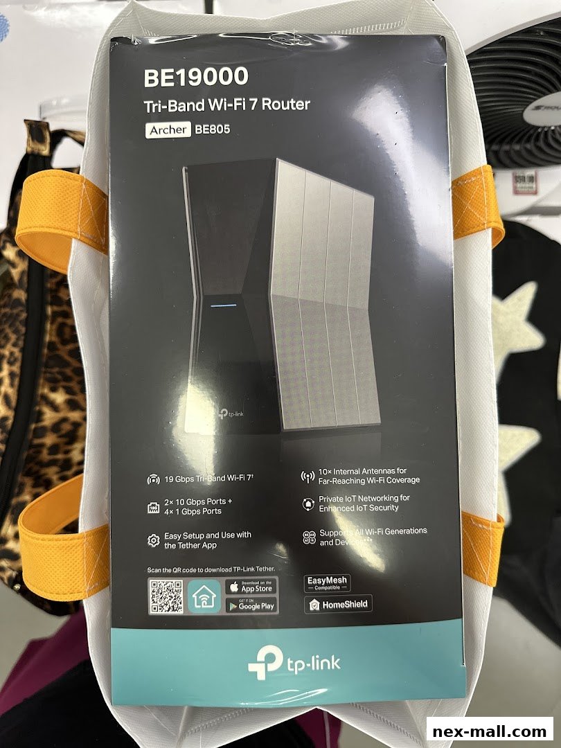 A TP-Link BE19000 Tri-Band Wi-Fi 7 Router, Archer BE805, is displayed in a shopping bag.