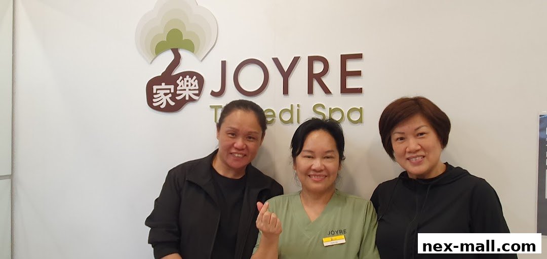 Three smiling women stand in front of the Joyre TCMedi Spa logo.