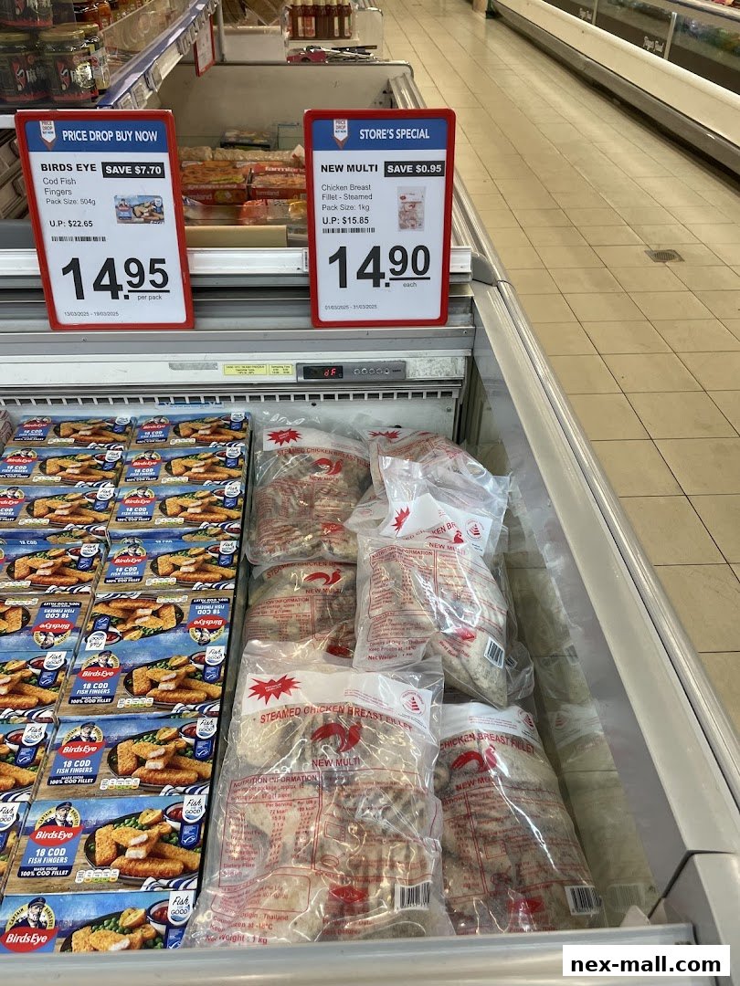 Frozen food products, including fish fingers and chicken breast fillets, displayed in a supermarket freezer aisle.