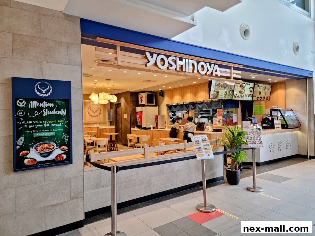 The Yoshinoya restaurant entrance with a student promotion sign and menu boards.