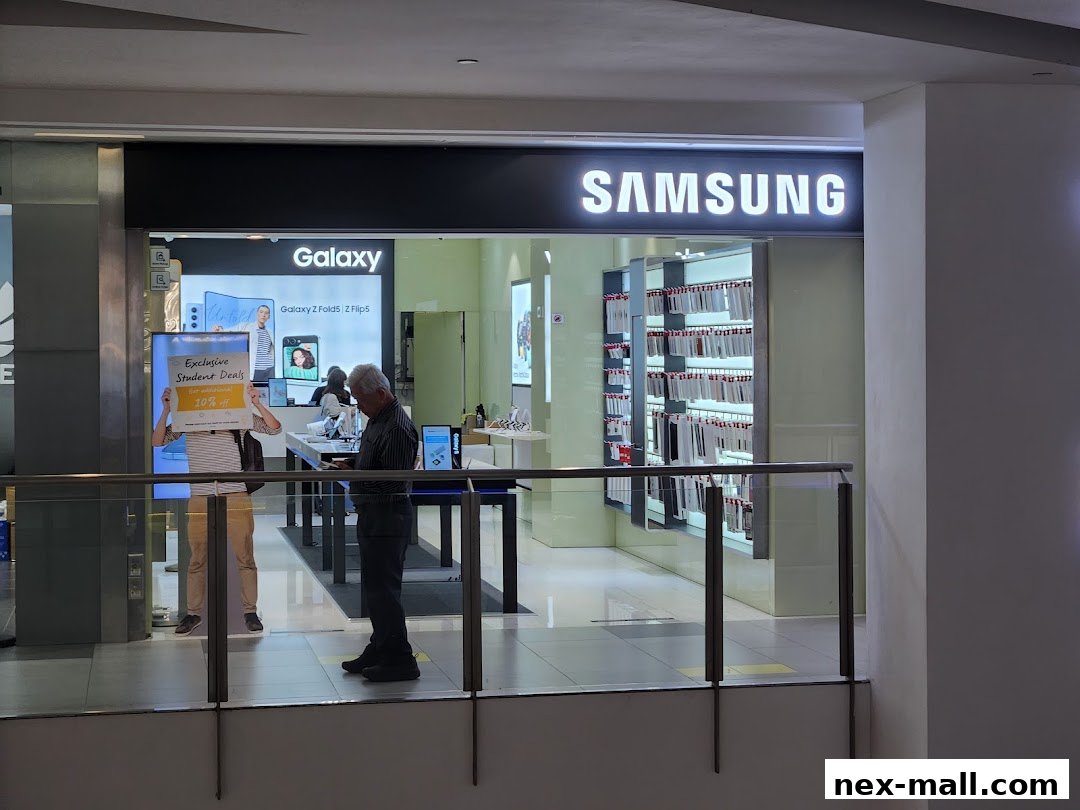 The Samsung Experience Store entrance with displays of Galaxy phones and accessories.