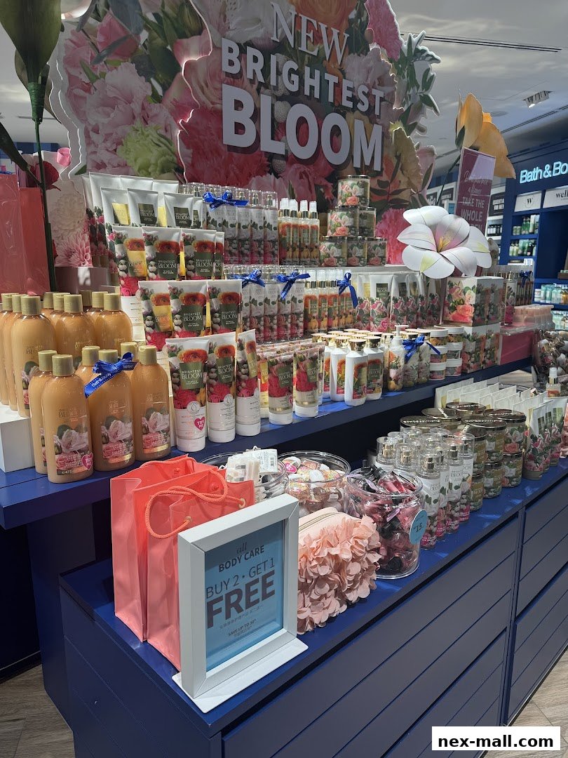 A display of Bath & Body Works products featuring floral scents and a 'Buy 2 Get 1 Free' promotion.
