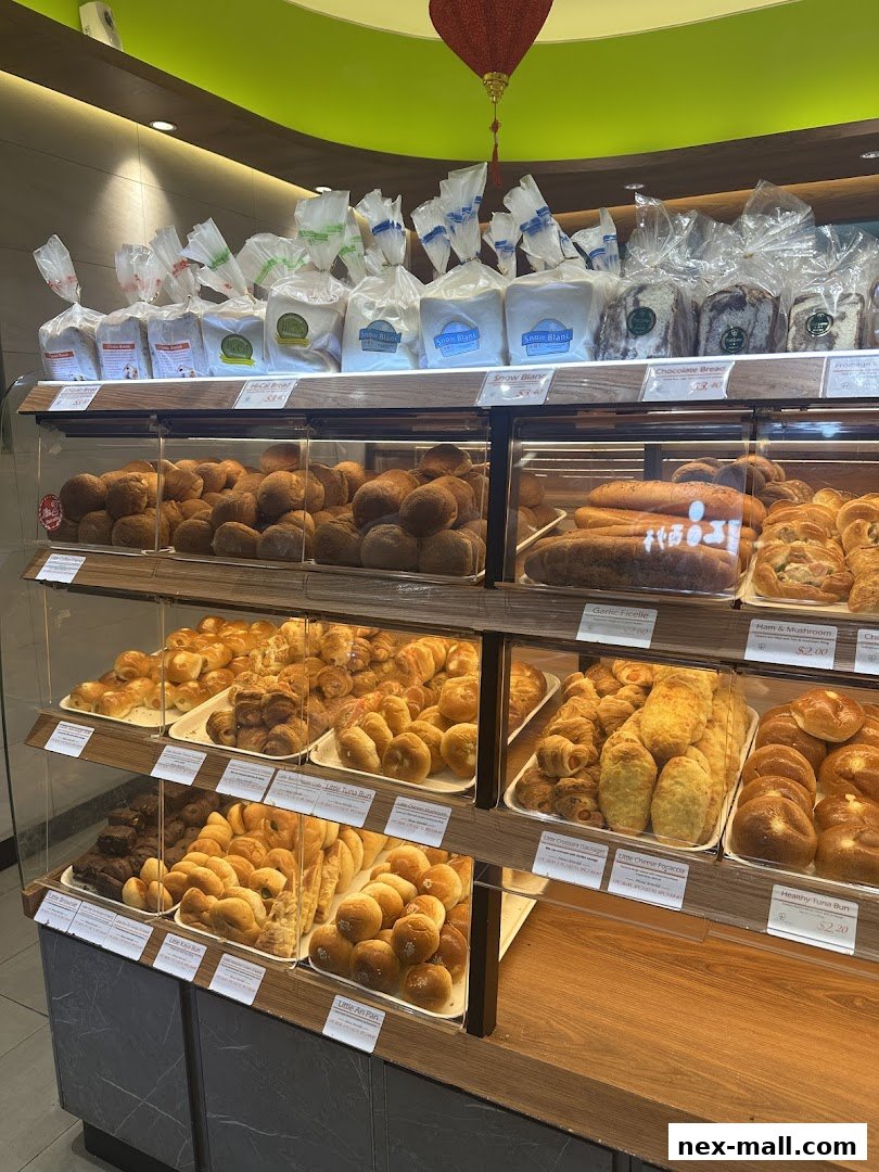 A display of freshly baked bread and pastries in a bakery.