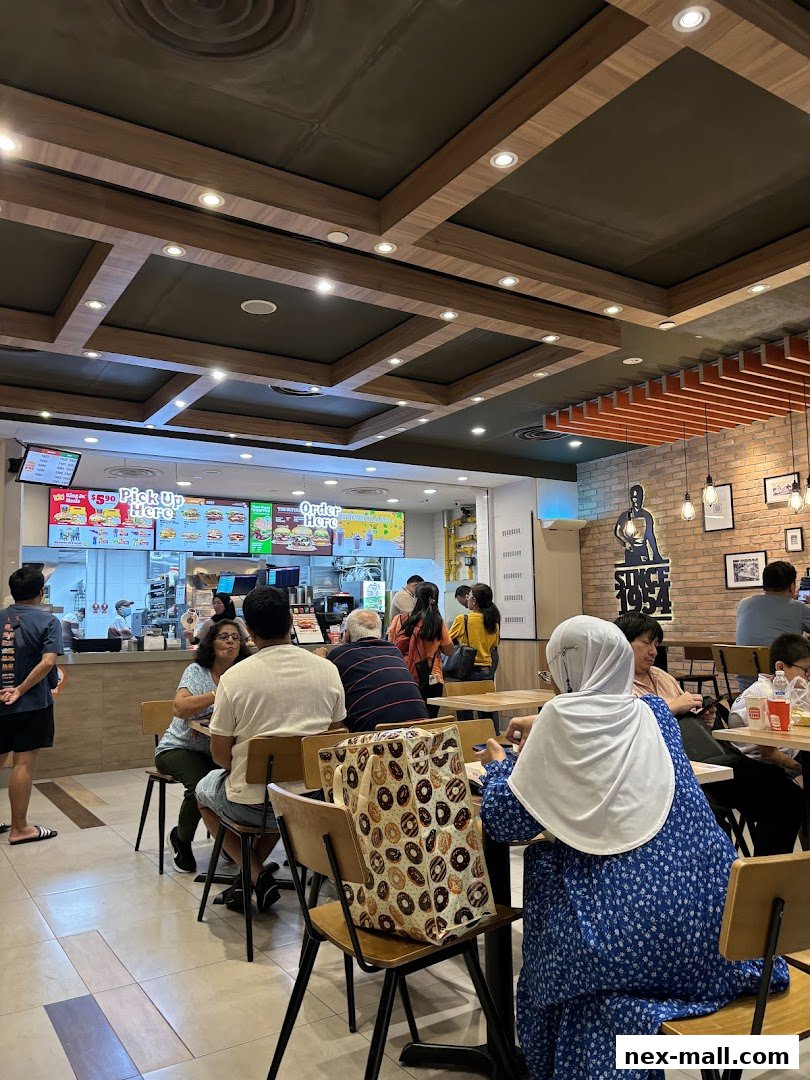People dining and ordering at a Burger King restaurant with a modern interior.