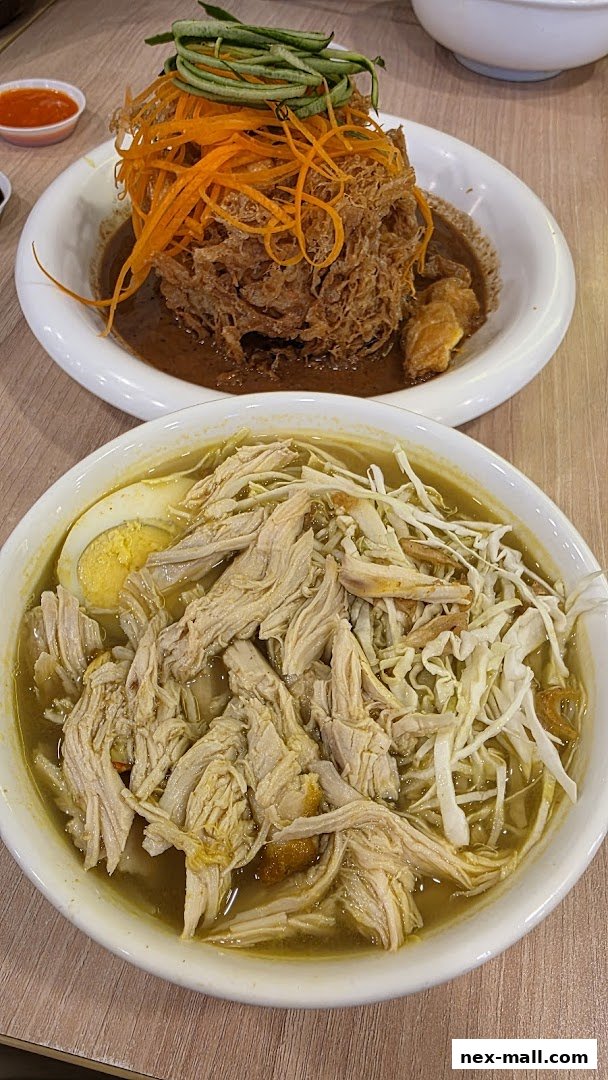 Two bowls of Indonesian cuisine, one with shredded chicken soup and the other with fried chicken and vegetables.