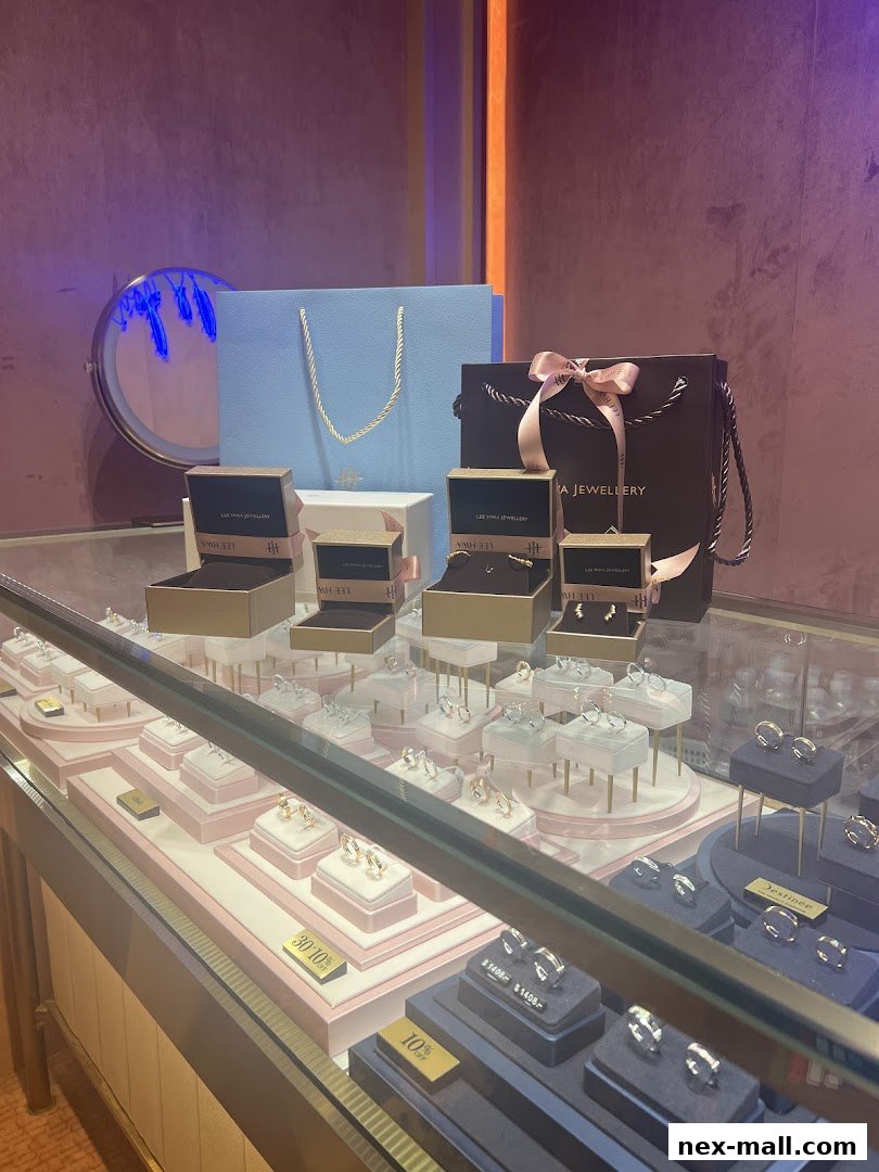 A display case filled with rings and jewelry, with branded shopping bags in the background.