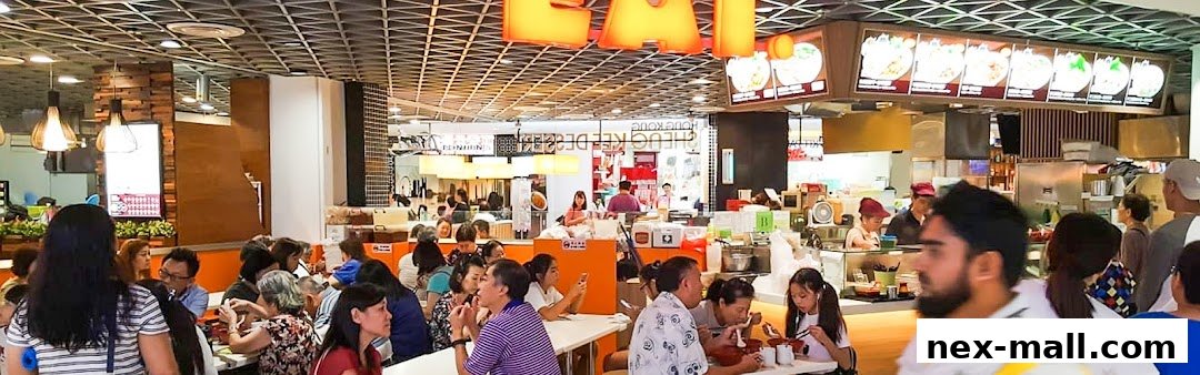 A busy food court with people dining and ordering at the 'EAT.' restaurant.
