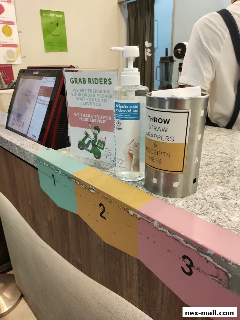 A counter at PlayMade with a POS system, hand sanitizer, and a bin for wrappers.