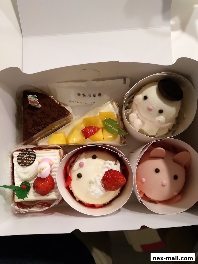 A box of assorted Châteraisé cakes and desserts, including character-themed treats.