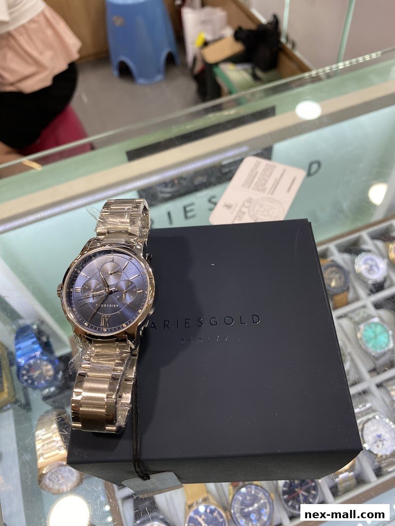 A stylish Aries Gold watch displayed with its black packaging on a glass counter.