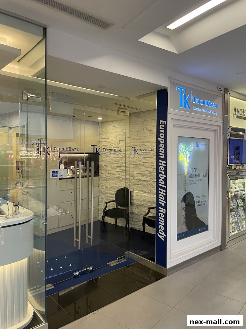 The entrance to TrichoKare, a hair loss and scalp treatment center, with a modern and clean interior.