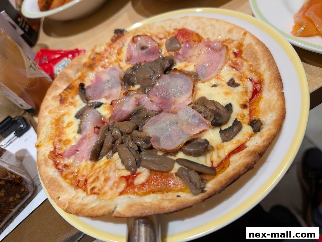 A close-up shot of a delicious pizza topped with bacon and mushrooms.