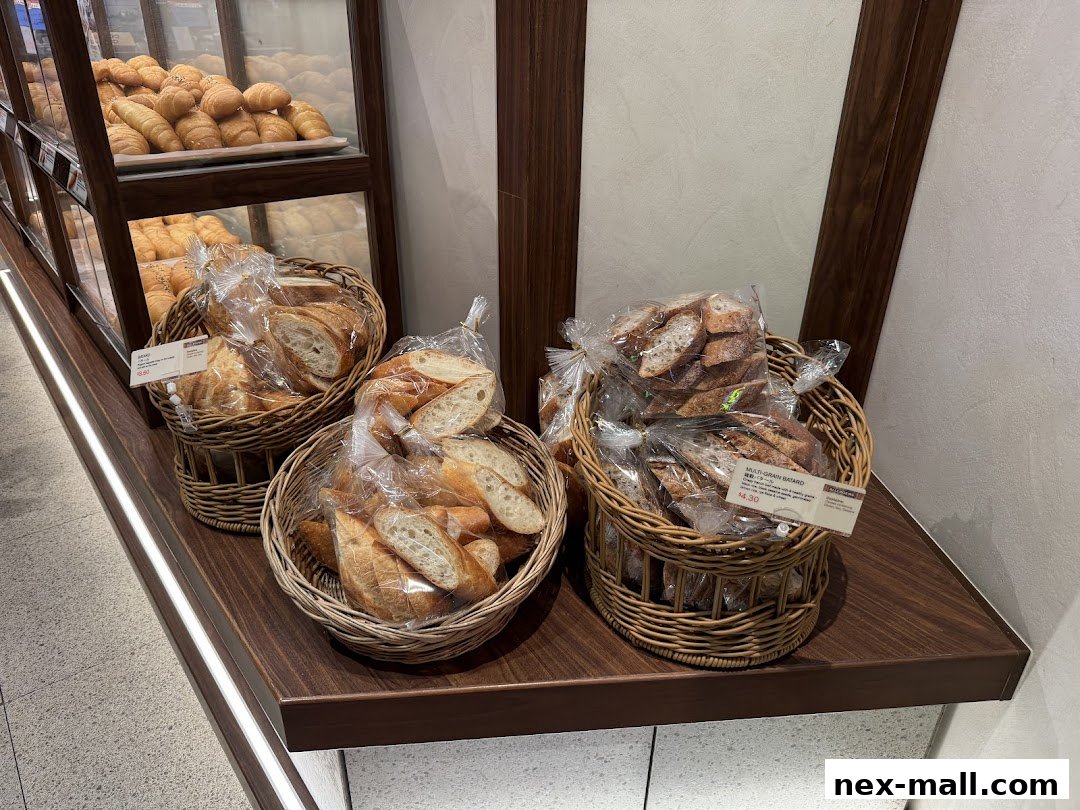 Baskets of freshly baked bread and pastries displayed in a bakery.