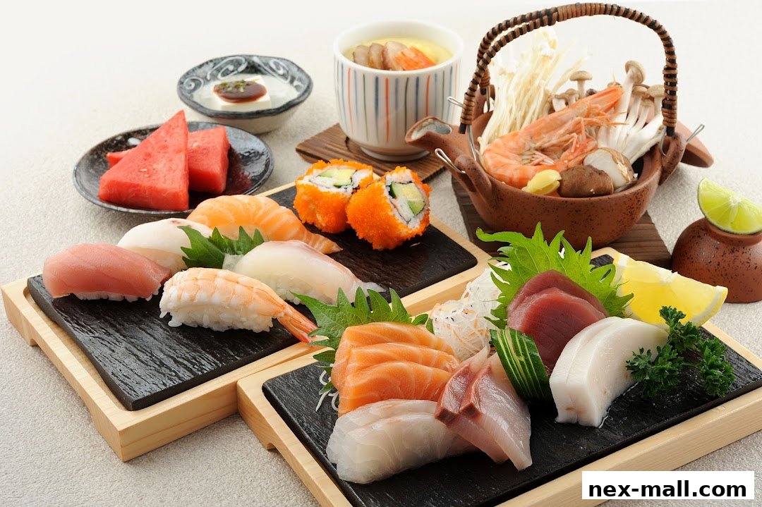 A beautifully arranged platter of assorted sushi, sashimi, and a steaming pot of chawanmushi.