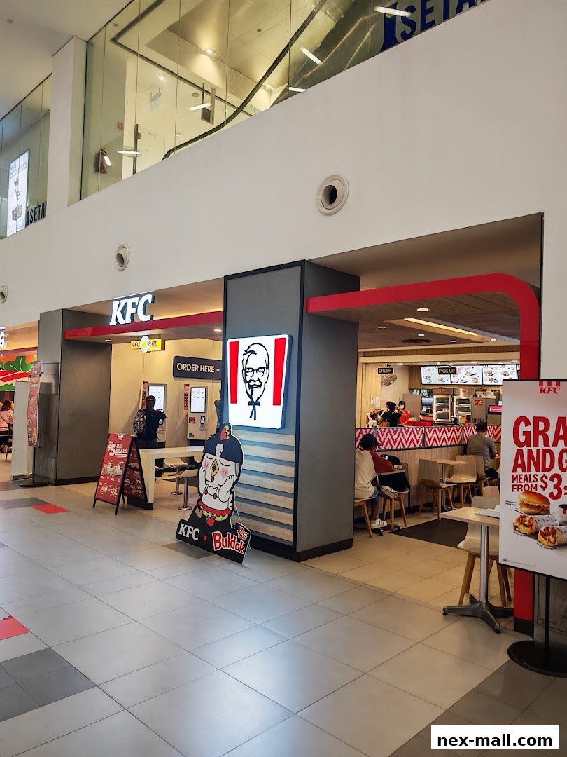The exterior of a KFC restaurant with a prominent Colonel Sanders logo and promotional signage.