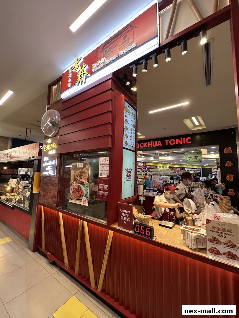A Shihlin Taiwan Street Snacks stall with staff serving customers and displaying food items.