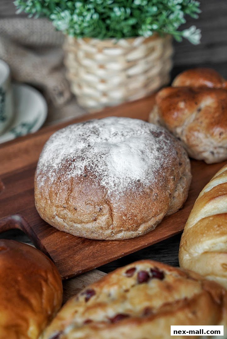 A close-up shot of freshly baked Japanese bread and pastries on a wooden board.