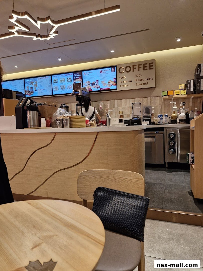 Interior view of a Tim Hortons coffee shop with a menu board and seating area.