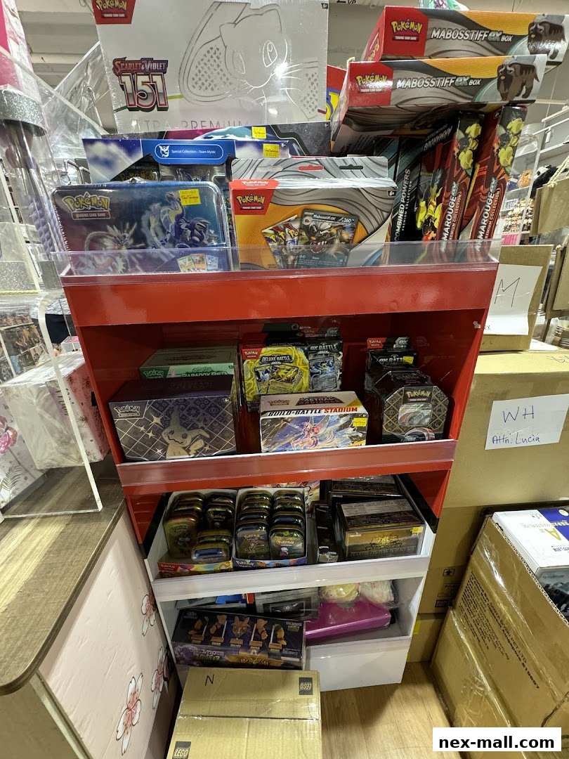 A display shelf filled with various Pokemon trading card game products and boxes.