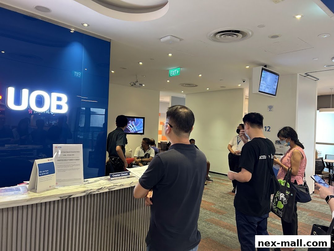 People waiting at the counter of a UOB bank branch with a 'Counter Closed' sign.