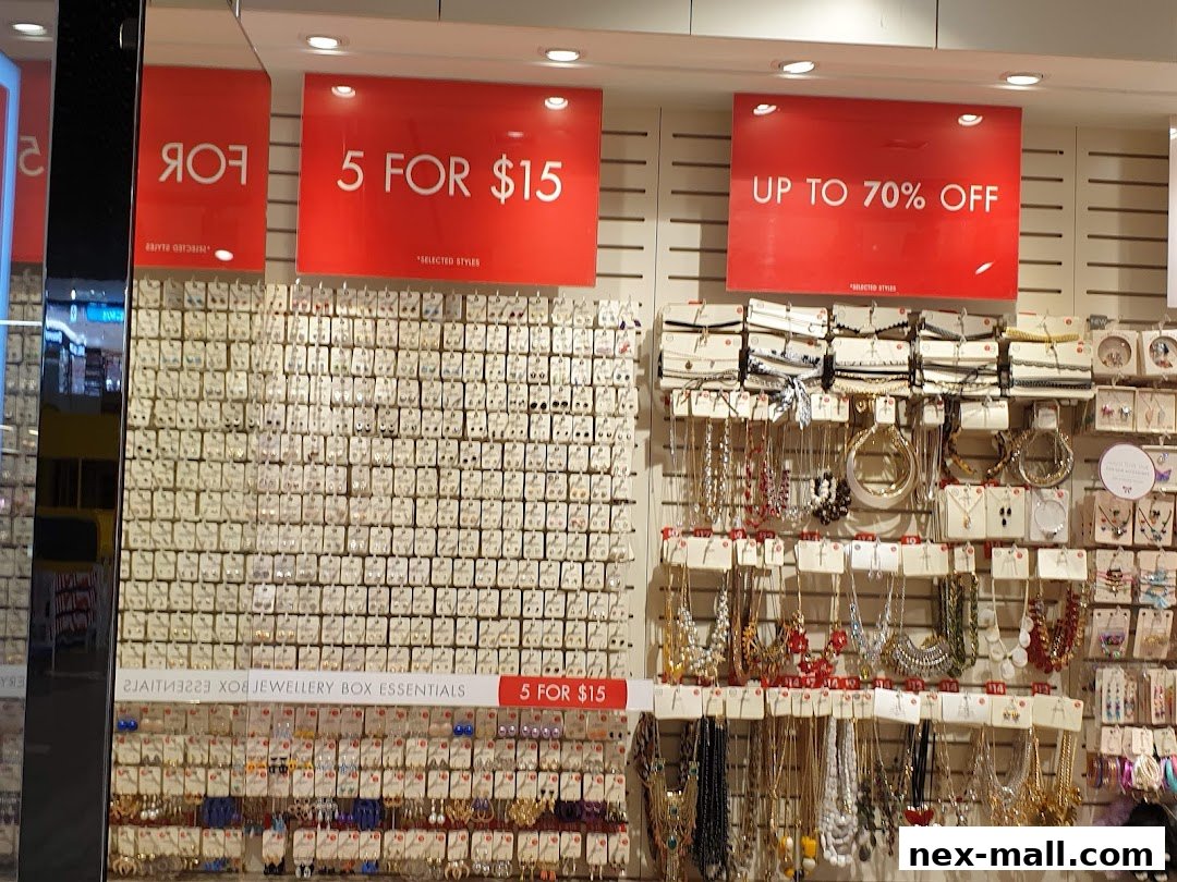 A display of jewelry with sale signs indicating discounts and multi-buy offers.