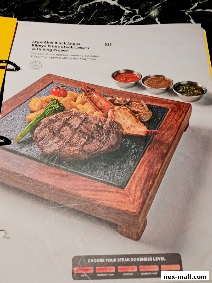 A menu item featuring Argentine Black Angus Ribeye Prime Steak with King Prawn.